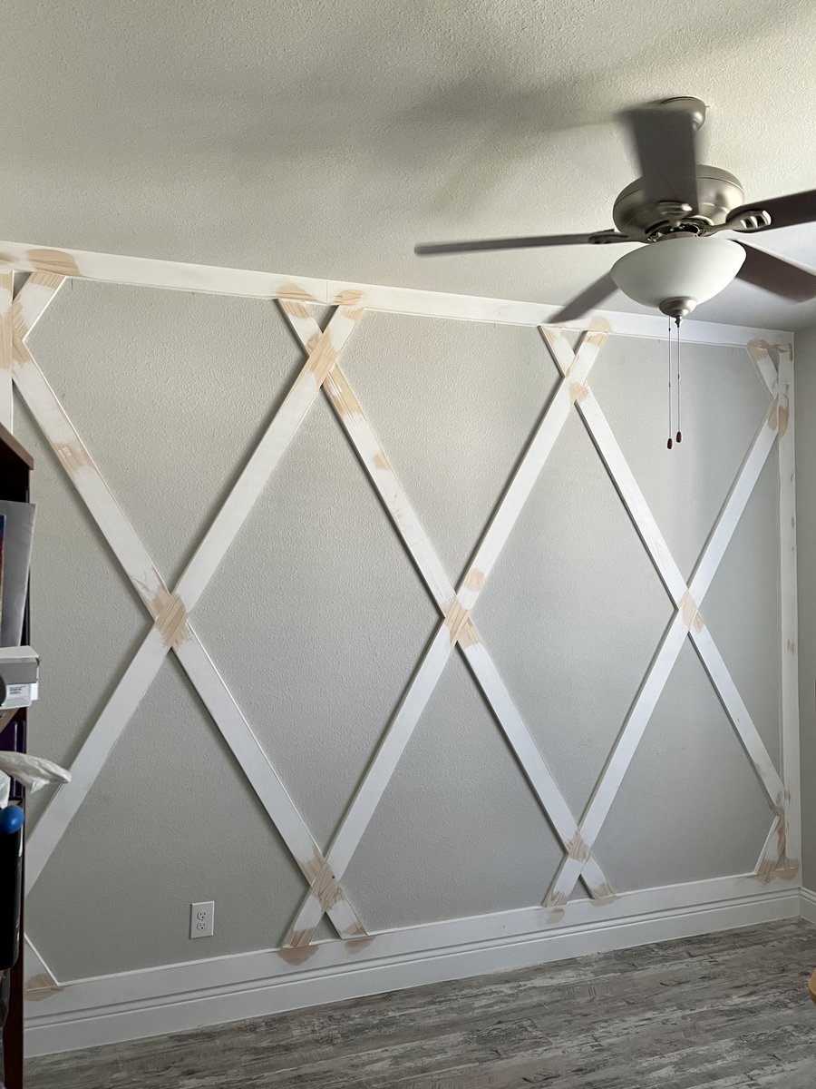 Custom diamond accent wall in progress, wood lattice taped and ready for paint
