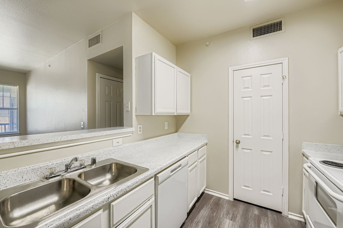Refinished white kitchen cabinets in an apartment