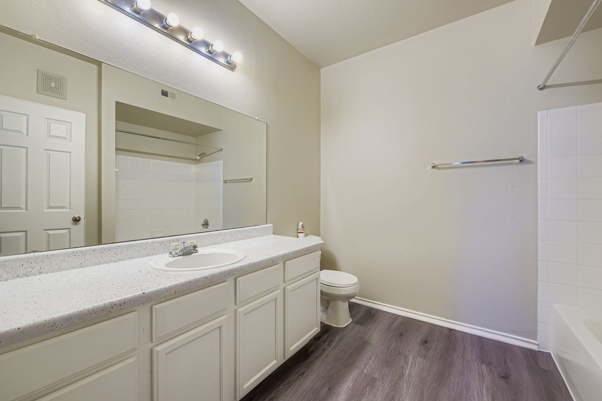 Freshly painted apartment bathroom with white cabinetry